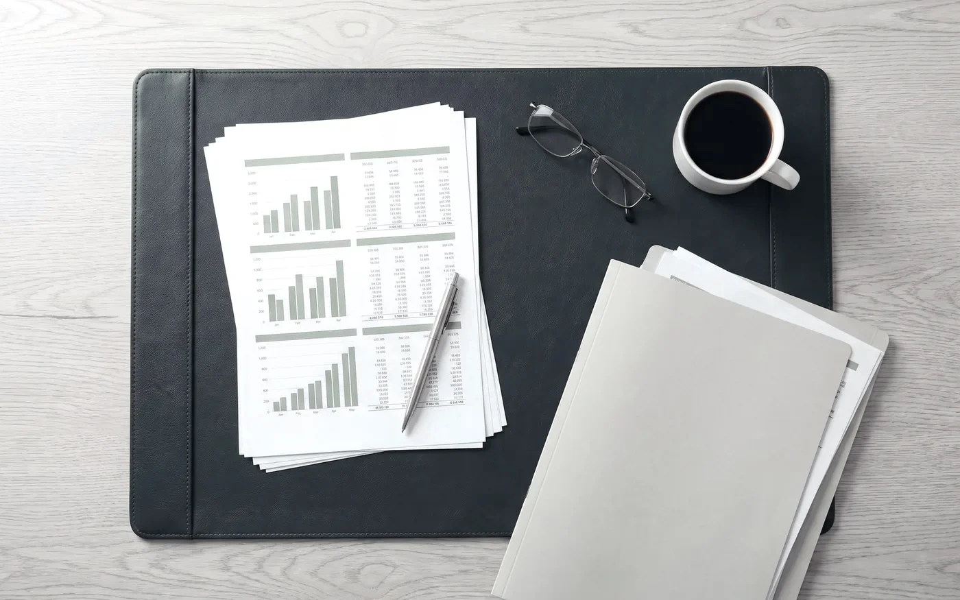 Printed profit and loss and balance sheet pages laid out on a desk for review